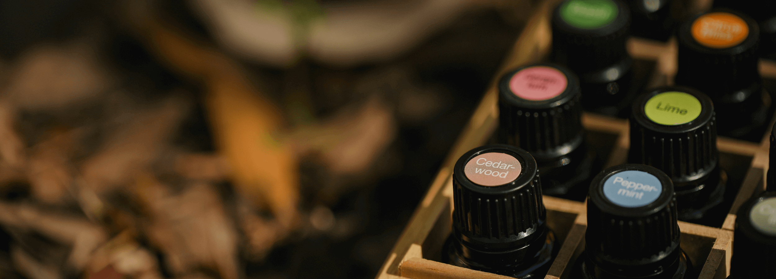 Essential oils stacked in wooden boxes, representing Ayurblooms' commitment to pure, potent ingredients and well-being from day one