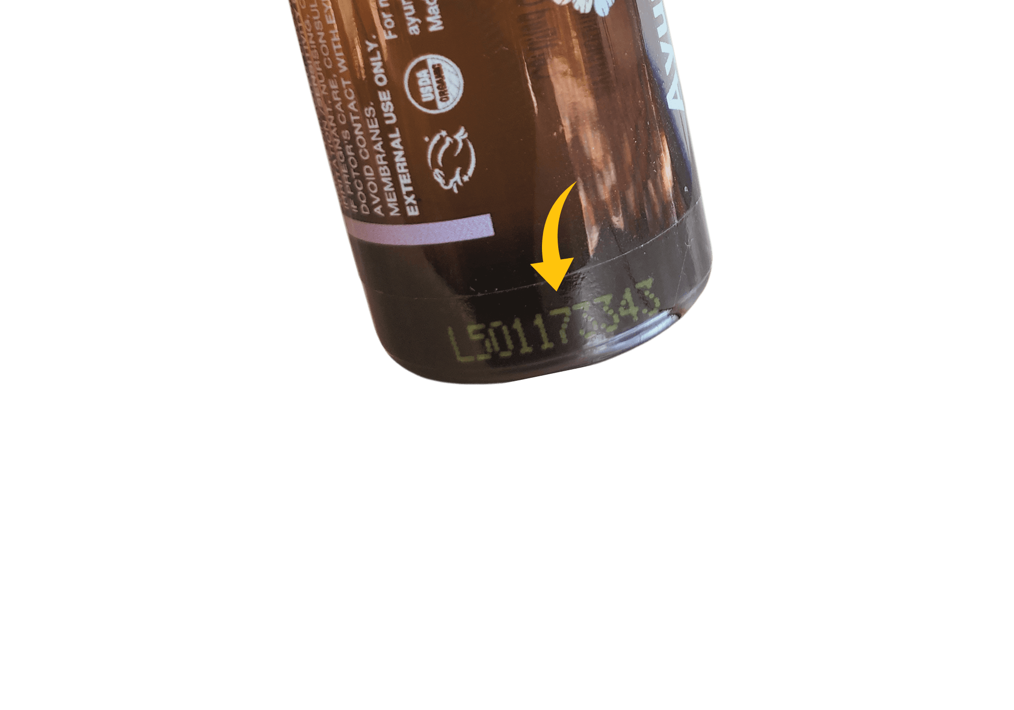 The image displays the batch numbers of Ayurblooms essential oils located on the bottom edge of the bottle.